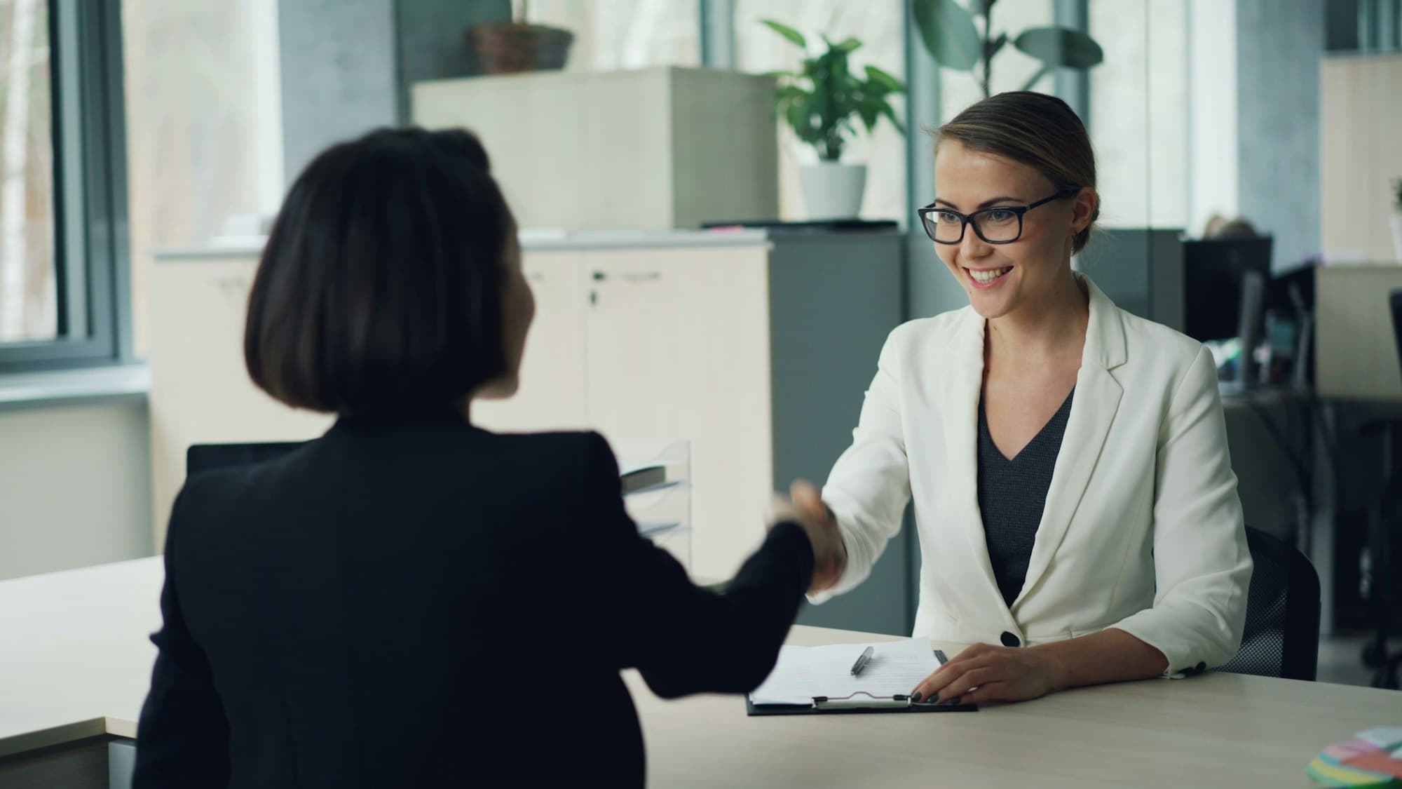 Two professionals shaking hands after a successful interview